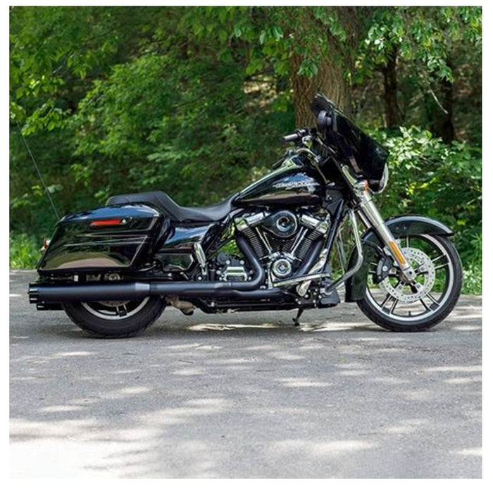 A black S&S Cycle motorcycle parked on a road near trees, featuring the 50 State Legal Mk45 TOURING MUFFLER for M8 TOURING MODELS - Black with Black Tracer End Cap.