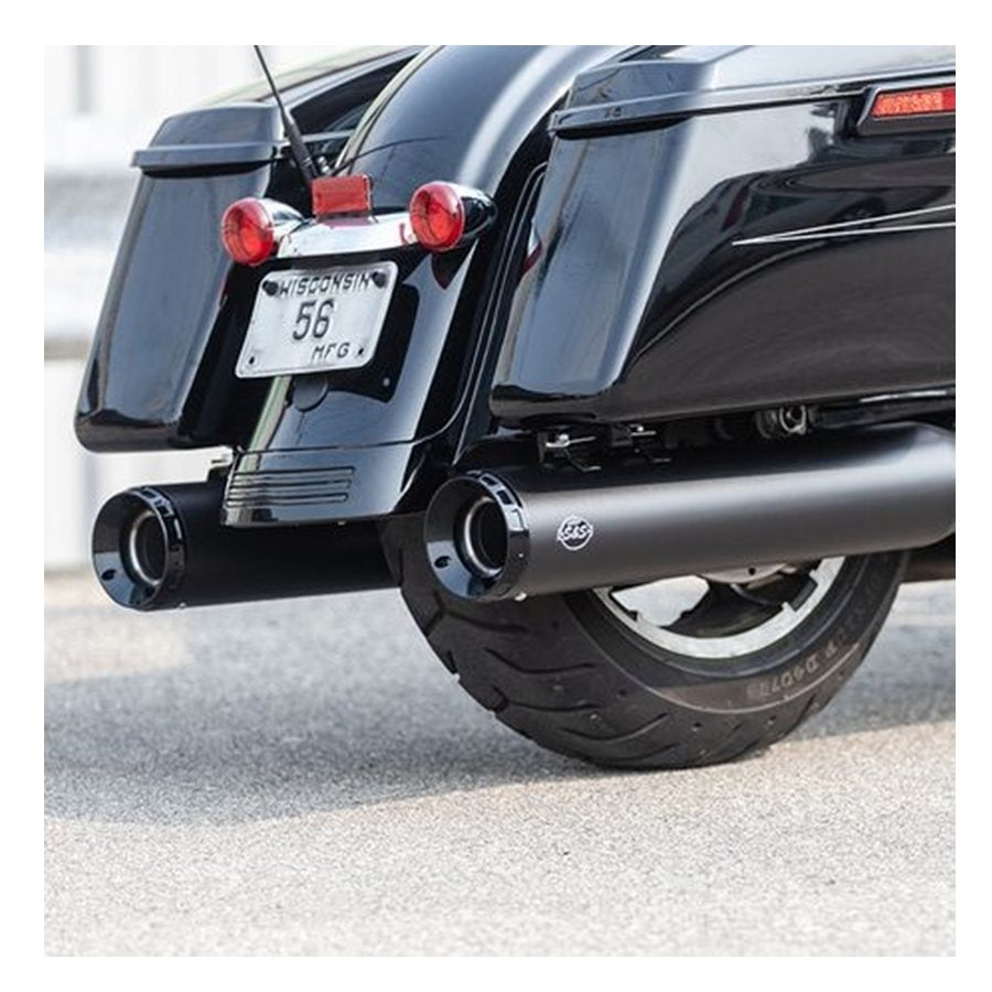 A black motorcycle with a black exhaust pipe and S&S Cycle GNX SLIP-ONS for M8 TOURING MODELS.
