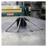 A group of Quickee Adjustable Pushrod Sets For 1999-'17 HD® Big Twins, 1991-'Up XL and 2017-'Up M8 Models by S&S Cycle on a table in a factory ready for installation.