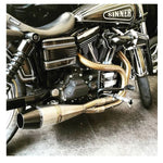 A black and silver motorcycle parked in a garage, featuring the Sawicki Speed Shorty 2 into 1 Pipe '91-'17 Dyna Models - Stainless on its Dyna Model.