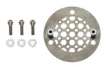 Close-up of a mechanical component featuring a "Pangor Cycles" branding on a circular metal plate. Various bolts, valves, and metal parts are visible, suggesting a part of an engine assembly, possibly connected to the Cheap Sucker Bird Catcher/Air Cleaner for S&S Super E Carburetors.