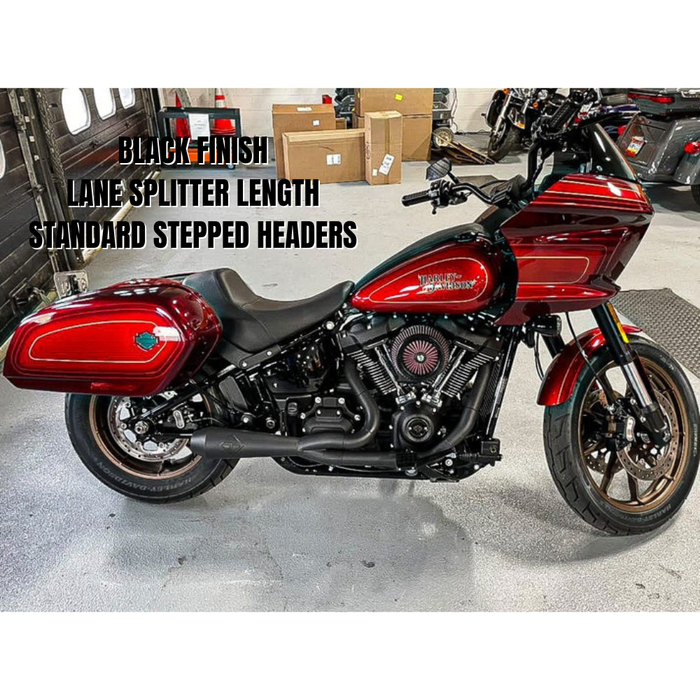 The SP Concepts Big Bore Exhaust for M8 Softail ST & Sport Glide (2018-Present) in stainless steel, featuring welded joints and a hexagonal logo emblem, rests on a metallic work surface, highlighting its premium finish.