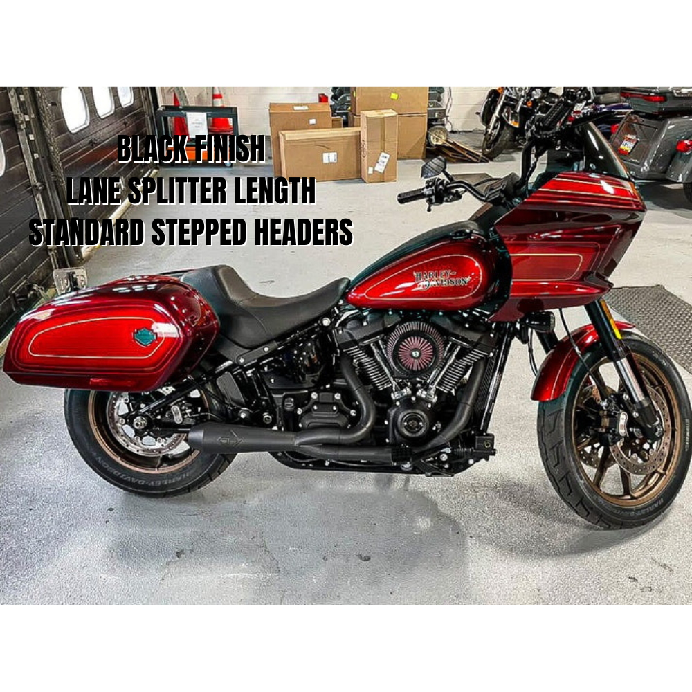 The SP Concepts Big Bore Exhaust for M8 Softail ST & Sport Glide (2018-Present) in stainless steel, featuring welded joints and a hexagonal logo emblem, rests on a metallic work surface, highlighting its premium finish.