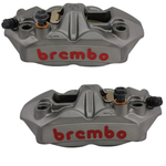 A Brembo M4 Radial Brake Caliper featuring a metallic finish, red Brembo branding, and visible mounting holes, displayed against a plain white background.