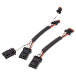 The Namz 15 Inch M8 Handlebar Control Wiring Extension set includes two black electrical wiring harnesses, each with connectors on both ends and multiple wires covered by a black sheath, secured with orange and black clips. These extensions are ideal for Softail or Sportster models.
