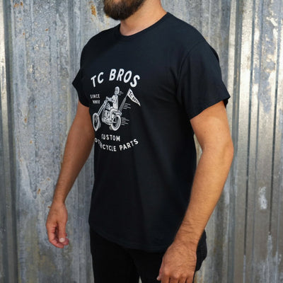 TC Bros. Rider - Black Tee with a vintage motorcycle print and the text "tc bros, since MMVI, custom motorcycle parts", crafted from ring-spun cotton.