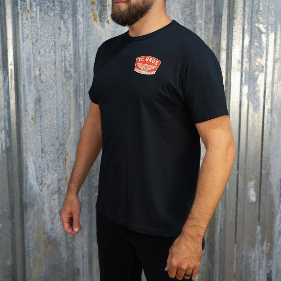 Winged Wheel - Black Tee - (Front Print) with a TC Bros logo on the chest, made from ring-spun cotton.