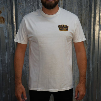 Winged Wheel - White Tee - (Front/Back Print), crafted from ring-spun cotton, featuring a small "TC Bros" logo on the left chest area.