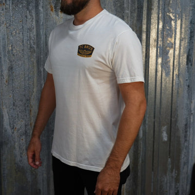 Winged Wheel - White Tee - (Front/Back Print), crafted from ring-spun cotton, featuring a small "TC Bros" logo on the left chest area.