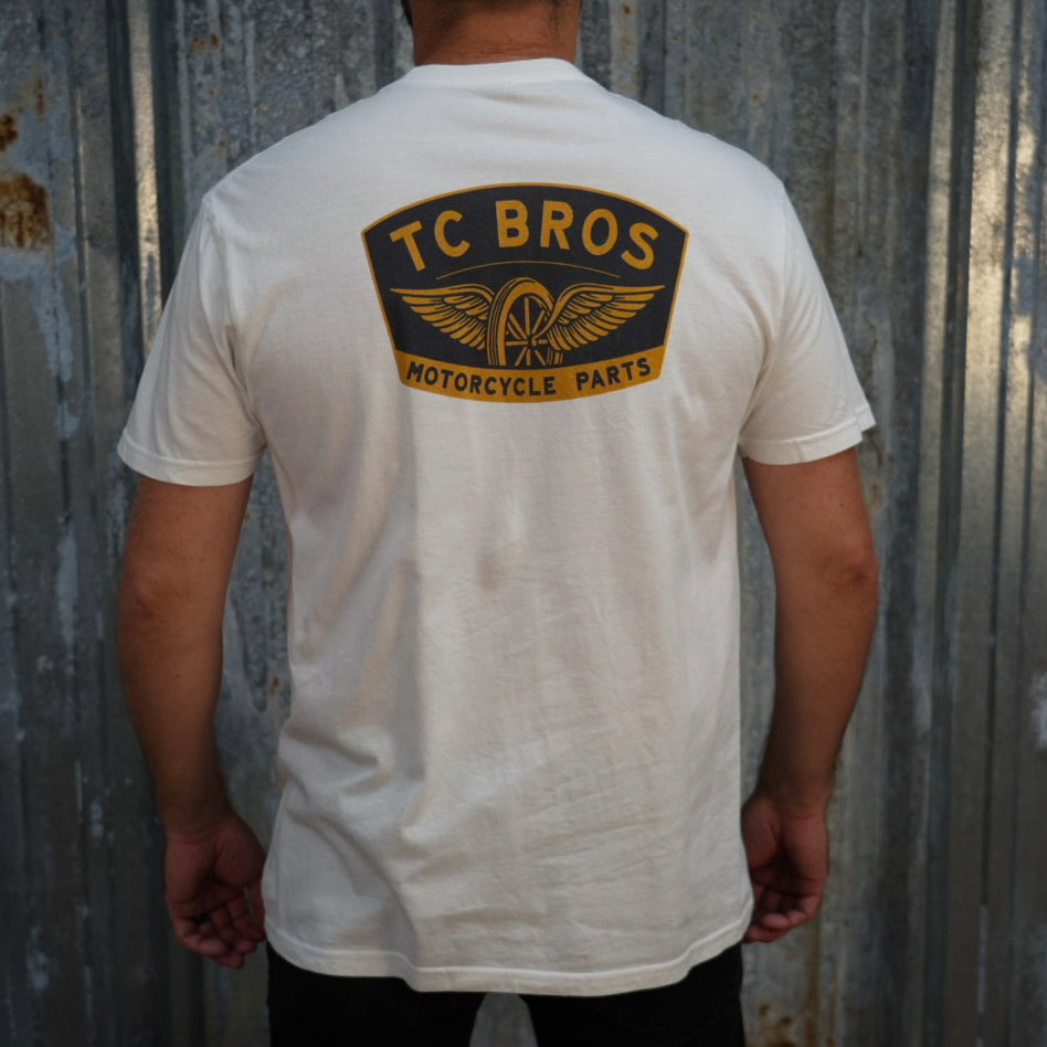 Winged Wheel - White Tee - (Front/Back Print), crafted from ring-spun cotton, featuring a small "TC Bros" logo on the left chest area.