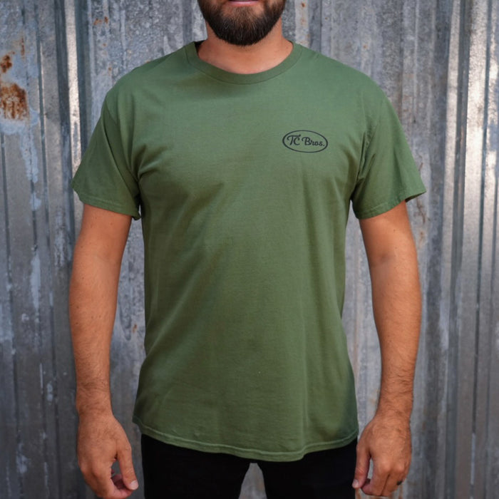 Plain olive green staple Pete - Military Green Tee with a small black logo on the left chest, printed on demand by TC Bros.