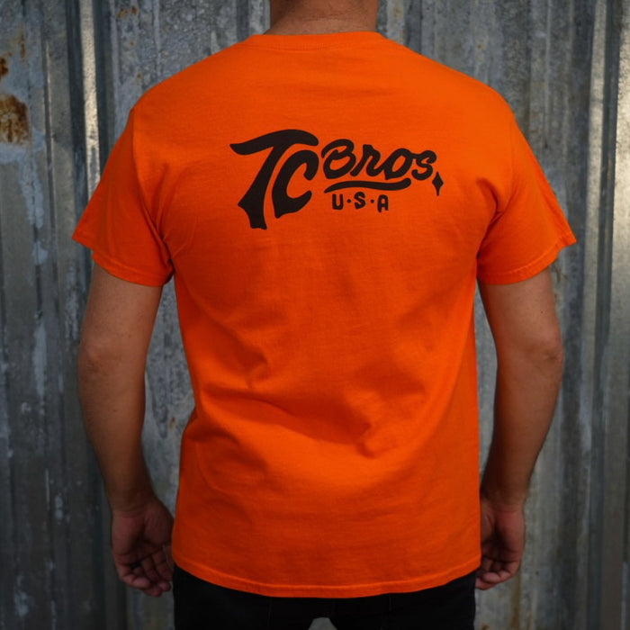 Orange Script - Orange Tee (Front/Back Print) staple t-shirt with a small black logo on the left chest area, printed on demand by TC Bros.