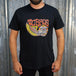 TC Bros. Wing Tee - Black, crafted from ring-spun cotton, with a graphic print featuring stylized wings, a motorcycle engine, and the text "turbos" in a flame-inspired font.