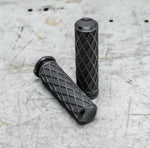 A pair of Arlen Ness Fusion Diamond Grips for Harley-Davidson cable throttle models, featuring a black rubber diamond pattern and shown against a white background. Their textured surface by Arlen Ness ensures a secure and comfortable hold for your ride.