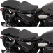 Two motorcycles are displayed side by side; one is a Harley-Davidson Sportster with a smooth leather seat, while the other features a Drag Specialties Bobber Solo Seat for 2010-2022 Harley-Davidson Sportster by Drag Specialties, distinguished by its quilted pattern. Both bikes have black finishes and share similar rear suspension and exhaust systems.
