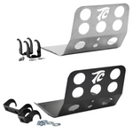 TC Bros. Skid Plate for Harley-Davidson Dyna 1991-2017 features two metal brackets (one silver, one black) with circular cutouts and "TC" logos, including mounting hardware and two black clamps—ideal for skid plate or engine guard setups.