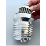 A person is holding a silver PC Racing Reusable Oil Filter for Harley 1980-2023 - Polished on a white surface, providing superior filtration for Harley motorcycles made between 1980-2023.