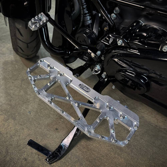 Three TC Bros. Pro Series MX Floorboards for Harley Davidson Bagger Touring Models with metallic finishes in silver, black, and gold featuring triangular cutout designs.