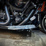 Close-up of TC Bros. Pro Series MX Floorboards for 1984-Up Harley-Davidson Touring, featuring billet aluminum footboards with geometric cutout designs on a concrete floor.