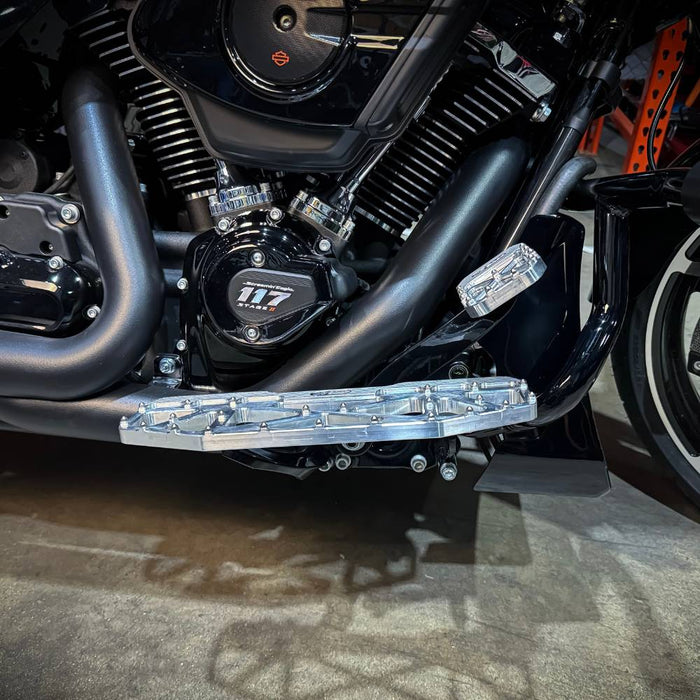 Three TC Bros. Pro Series MX Floorboards for Harley Davidson Bagger Touring Models with metallic finishes in silver, black, and gold featuring triangular cutout designs.