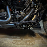 Close-up of TC Bros. Pro Series MX Floorboards for 1984-Up Harley-Davidson Touring, featuring billet aluminum footboards with geometric cutout designs on a concrete floor.