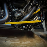 Close-up of TC Bros. Pro Series MX Floorboards for 1984-Up Harley-Davidson Touring, featuring billet aluminum footboards with geometric cutout designs on a concrete floor.