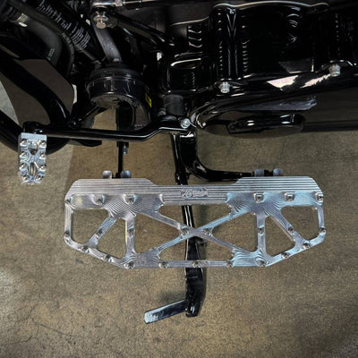 Three TC Bros. Pro Series MX Floorboards for Harley Davidson Bagger Touring Models with metallic finishes in silver, black, and gold featuring triangular cutout designs.