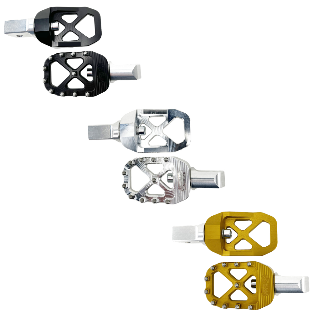 Five TC Bros. Pro Series MX Footpegs for 2018-Up Harley-Davidson (Passenger Position) in black, silver, and gold are arranged diagonally on a white background, showing various designs and finishes.