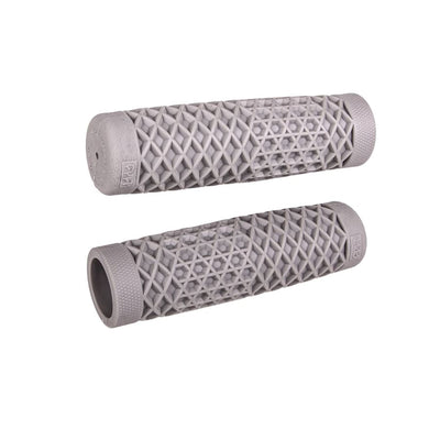 ODI Vans and Cult Grips for 1" handlebars feature a waffle pattern and come in black, brown, maroon, and orange. Textured rubber grips inspired by the Vans x CULT design are arranged on a white surface.