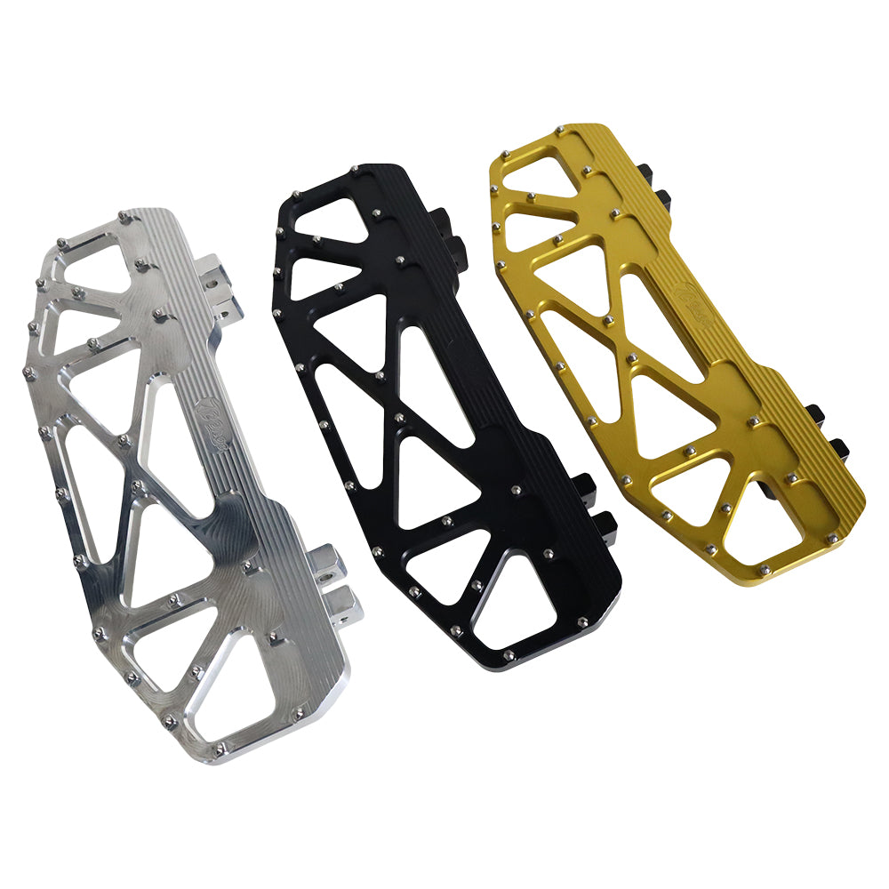 Three TC Bros. Pro Series MX Floorboards for Harley Davidson Bagger Touring Models with metallic finishes in silver, black, and gold featuring triangular cutout designs.