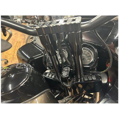 The TC Bros. Pro Series Riser Adapter for 2015-2023 Harley Road Glide, a sleek black and silver mechanical component with cylindrical parts and a solid frame, is perfect for enhancing your Harley Davidson.