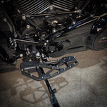 TC Bros. Pro Series MX Slim Floorboards for Harley Davidson Bagger Touring Models feature a skeletal design with metal pins, resembling high-performance pedals in silver, black, and gold. Arranged diagonally, they offer a striking visual appeal.