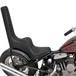 Two black, diamond-stitched TC Bros. King & Queen Hardtail Seats by TC Bros.—one mounted on a partially shown motorcycle—evoke classic Harley-Davidson chopper style.