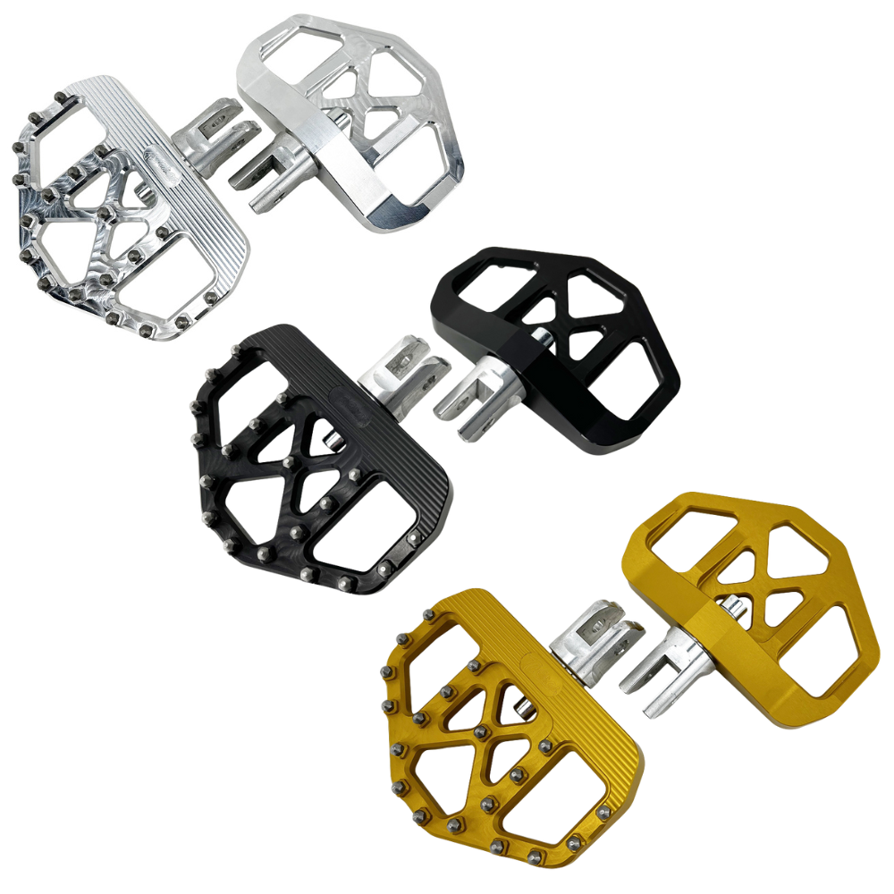 Three TC Bros. Pro Series MX Mini Floorboards for Harley-Davidson, in silver, black, and gold, are diagonally arranged on a white background.