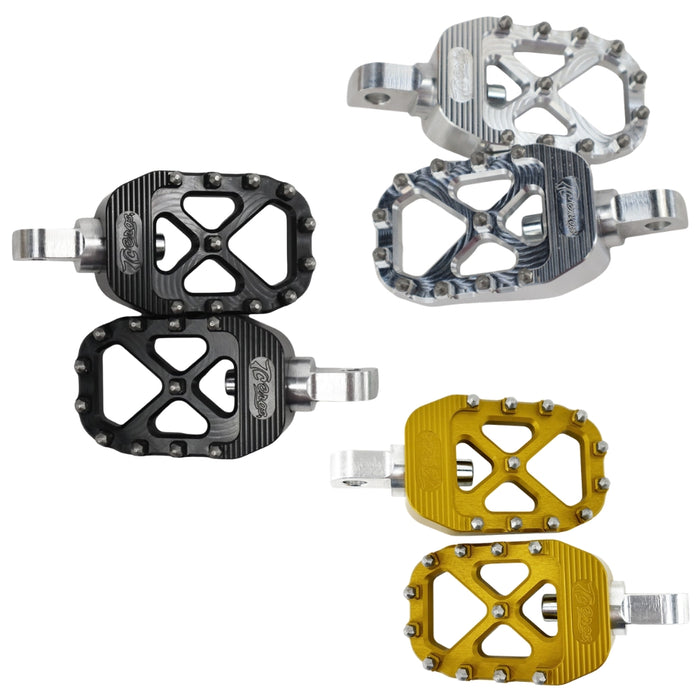 Three pairs of TC Bros. Pro Series MX Footpegs for 1977-2022 Harley-Davidson in silver, black, and gold, each featuring metal pins and a flat, open-frame design inspired by MX foot pegs for superior grip and performance.