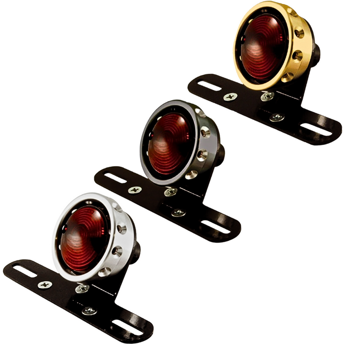 The Mid-USA Vintage Drilled Tail Light features a round design with a red lens and aluminum housing in silver, black, or gold. Each mounts on a black bracket with two screw holes and works with a 12V dual-filament bulb for reliable performance.