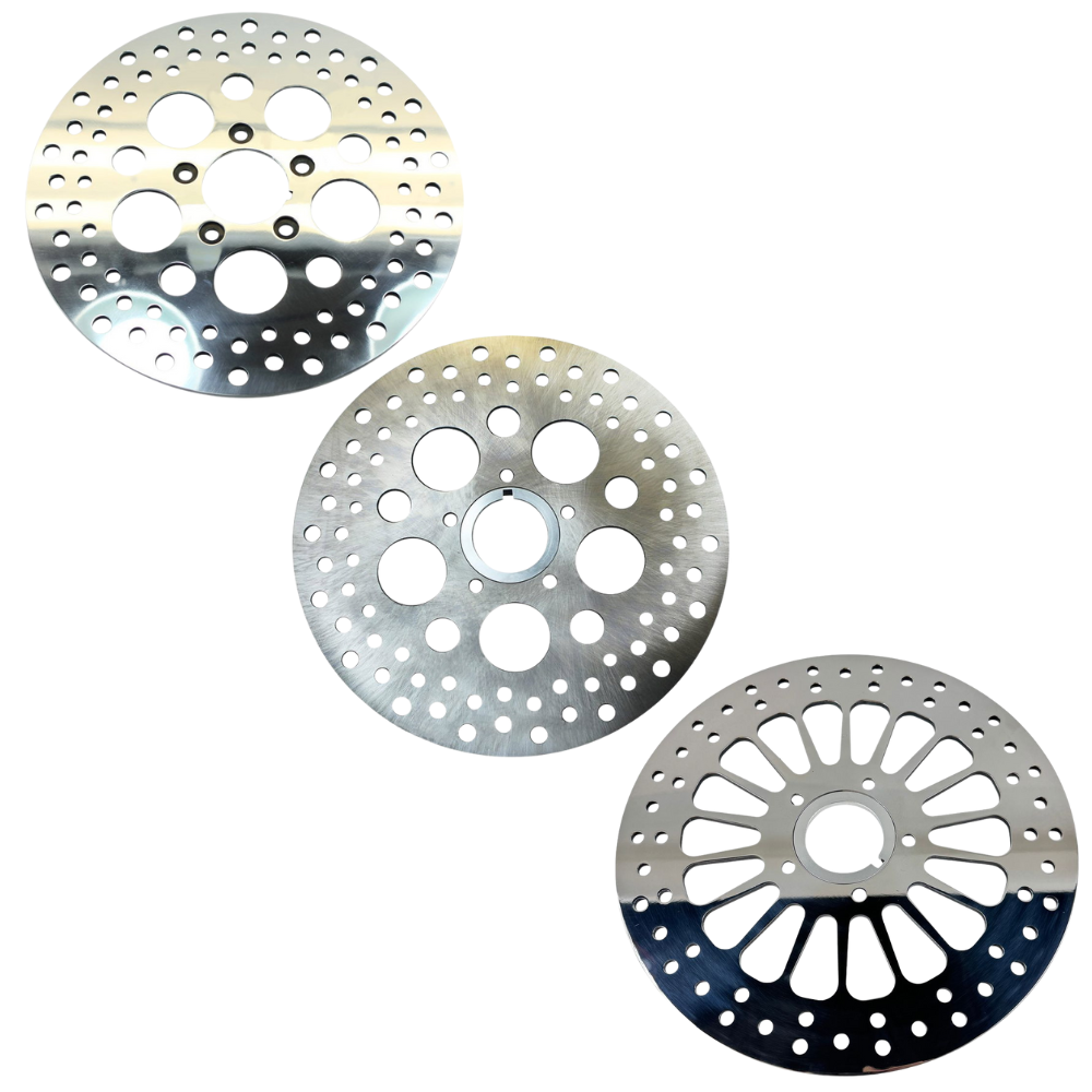 Three Moto Iron® 11.5" Front Brake Rotors for Harley-Davidson 1984-2013, with perforated patterns and central holes, are arranged diagonally on a white background.