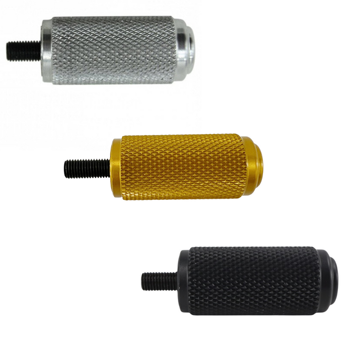 The TC Bros. Nomad Shift/Brake Peg for Harley-Davidson features CNC-machined aluminum pegs in silver, gold, and black with textured grips and threaded bolts. Ideal as a shift or brake peg. "NOMAD SHIFT/TOE PEG" text appears at the top.