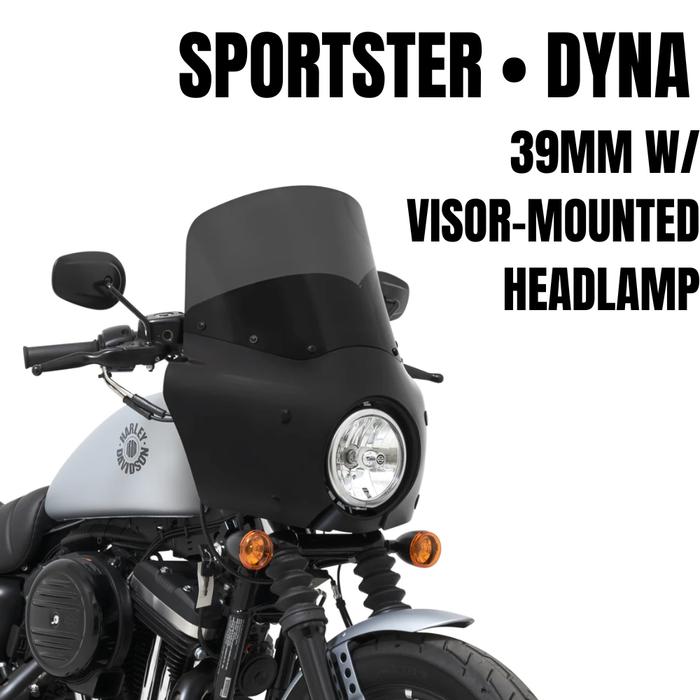 A Memphis Shades Road Warrior Fairing Kit for 1987-2022 Harley-Davidson Dyna with 39mm fork and visor is mounted on a gray Dyna, featuring a central headlight and two orange turn signals.