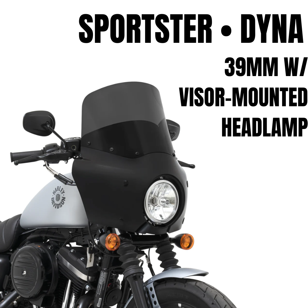 A Memphis Shades Road Warrior Fairing Kit for 1987-2022 Harley-Davidson Dyna with 39mm fork and visor is mounted on a gray Dyna, featuring a central headlight and two orange turn signals.