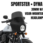 A Memphis Shades Road Warrior Fairing Kit for 1987-2022 Harley-Davidson Dyna with 39mm fork and visor is mounted on a gray Dyna, featuring a central headlight and two orange turn signals.