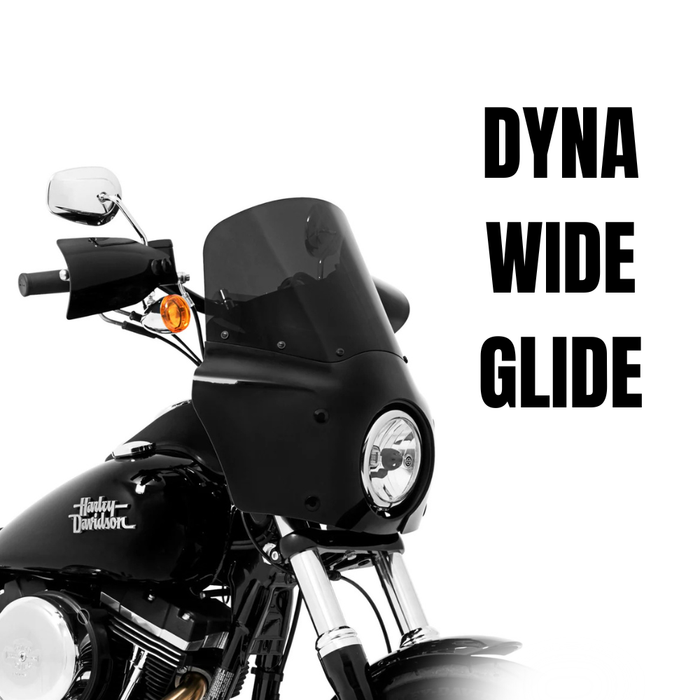 A black 2006-2017 Harley-Davidson Dyna Wide Glide features a Memphis Shades Road Warrior Fairing for superior wind protection, with "DYNA WIDE GLIDE" boldly displayed on a white background.