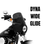 A black 2006-2017 Harley-Davidson Dyna Wide Glide features a Memphis Shades Road Warrior Fairing for superior wind protection, with "DYNA WIDE GLIDE" boldly displayed on a white background.