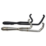 A dimly lit garage houses a gray motorcycle equipped with an SP Concepts Mid Length Elsinore Exhaust for Harley Davidson M8 Touring Bagger 2017-Up. Shelves surround it, with an American flag providing a striking backdrop.