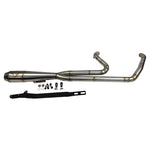 In a workshop with polished metal exhaust pipes, a worker, and an American flag above, the SP Concepts Works Edition Mid Length Elsinore Exhaust for Harley Davidson M8 Touring Bagger 2017-Up is showcased as ideal for enhancing performance.