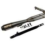 In a workshop with polished metal exhaust pipes, a worker, and an American flag above, the SP Concepts Works Edition Mid Length Elsinore Exhaust for Harley Davidson M8 Touring Bagger 2017-Up is showcased as ideal for enhancing performance.