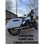 The SP Concepts Exhaust System for 2017-Up Harley-Davidson Touring features two metal pipes, one black and one polished silver, displayed on white. This 2-into-1 system by SP Concepts is perfect for your Harley Touring model.