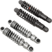 Two pairs of Drag Specialties Premium Adjustable Height Shocks for 1957-2017 Harley-Davidson—one set black, one chrome—are displayed against a white background.