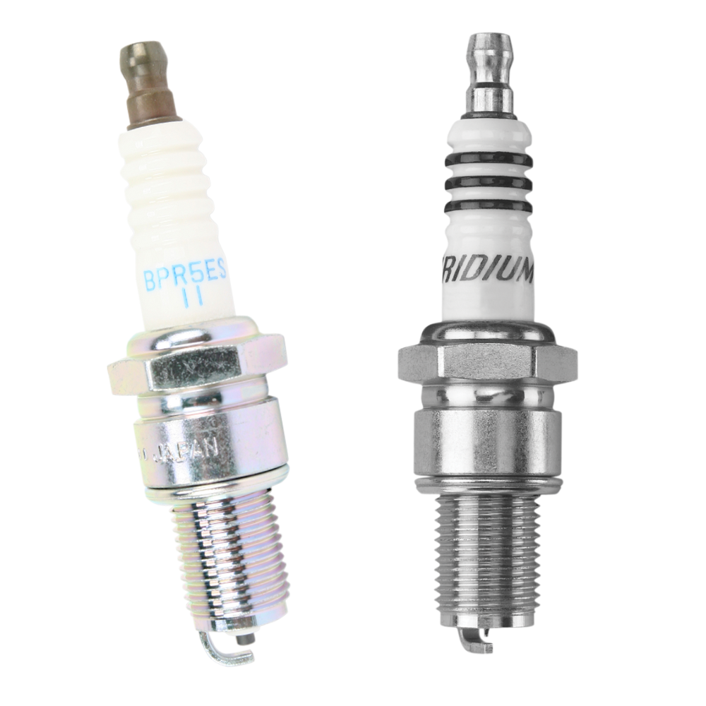 Two NGK Spark Plugs for Harley-Davidson Shovelhead and Evolution side by side, one white with blue text and one silver with the word “IRIDIUM” printed on the ceramic insulator.