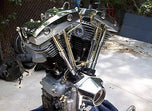 A pair of OLD-STF Brass Shovelhead Rocker Box Split Oil Lines and a piece of metal on a white background.